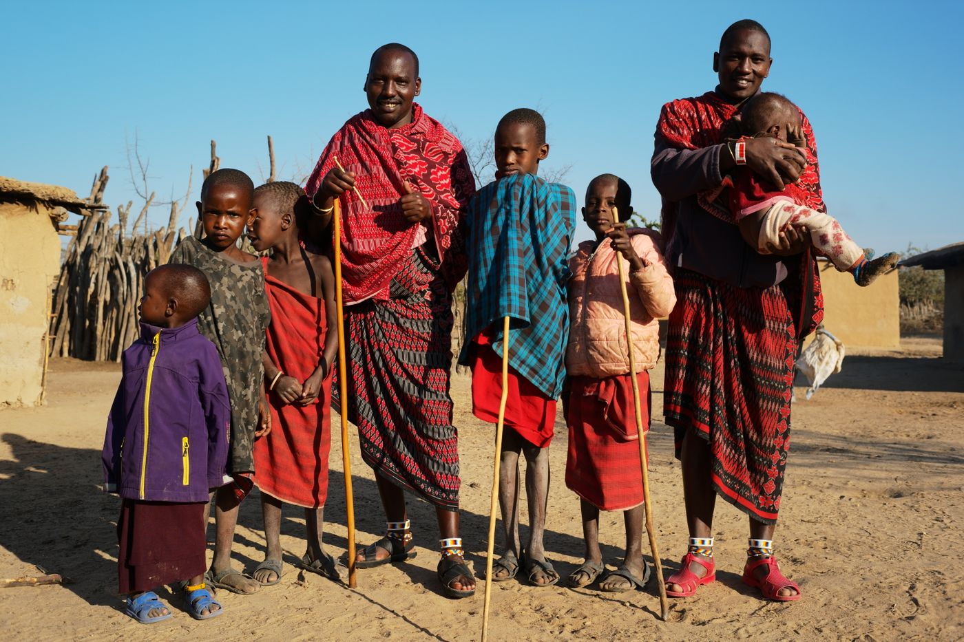 Maasai family in traditional attire outdoors