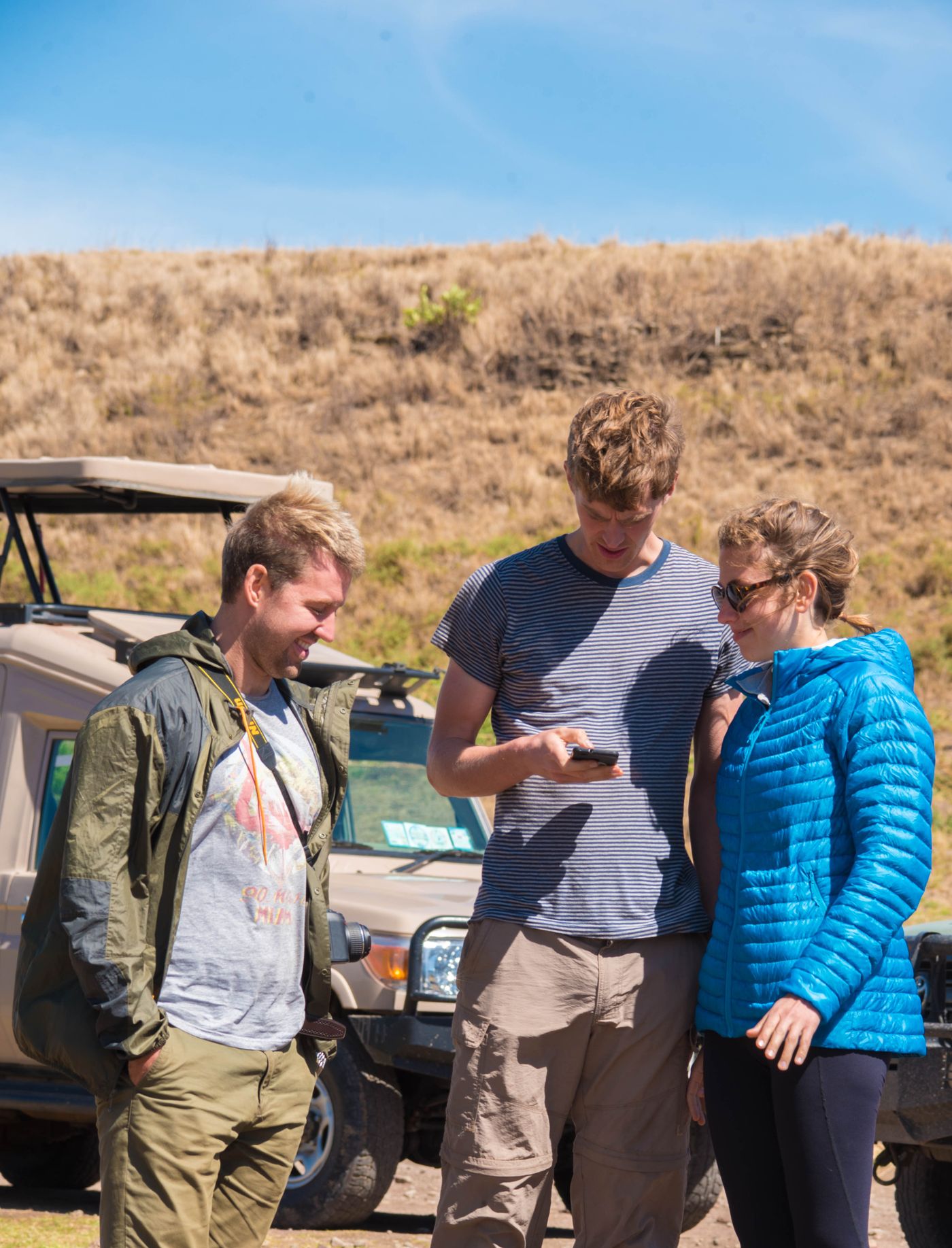 Friends on safari adventure in Tanzania with jeep