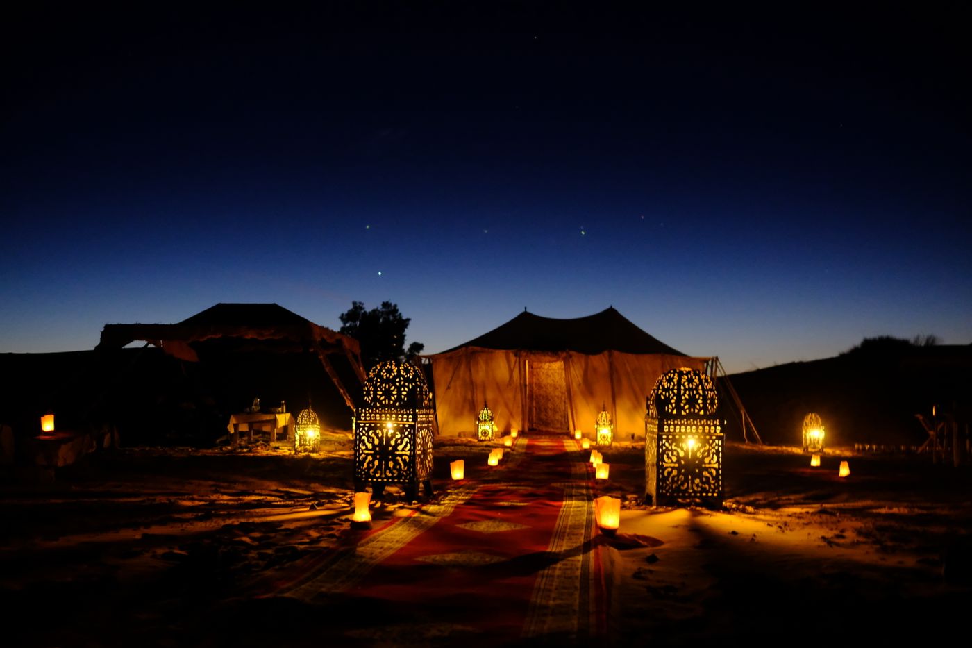 Illuminated tents with lanterns at twilight
