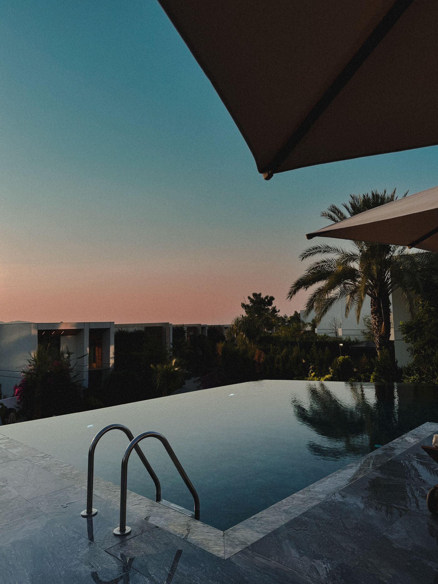 Infinity pool reflecting sunset colors