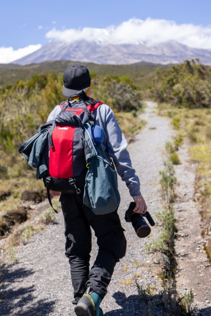 Hiker with backpack on a trail toward Mount Kilimanjaro, Tanzania