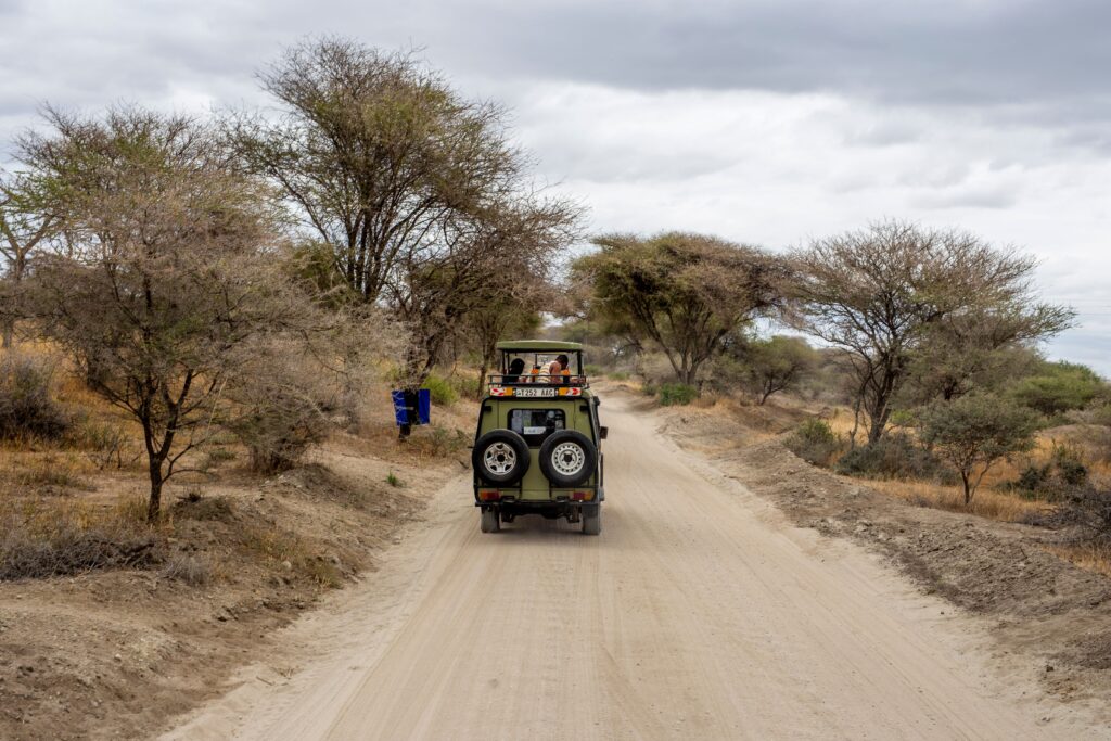 Are Tanzania Safaris Safe? What Travelers Actually Need to Know 2 Safari jeep on a dusty road in Tanzania