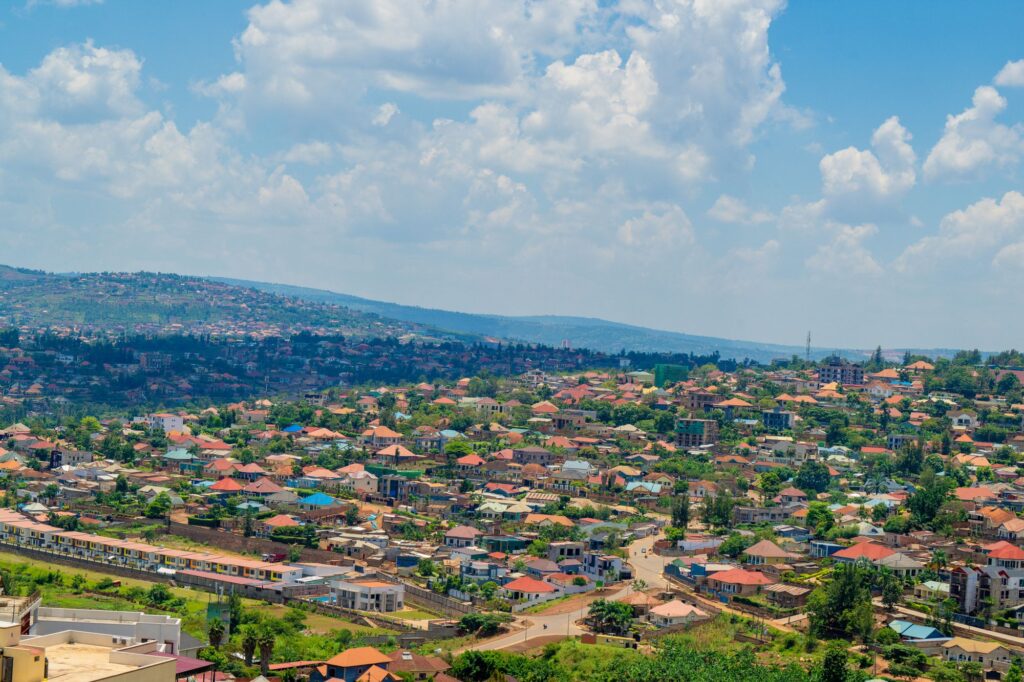 Aerial view of Kigali cityscape with colorful rooftops and greenery