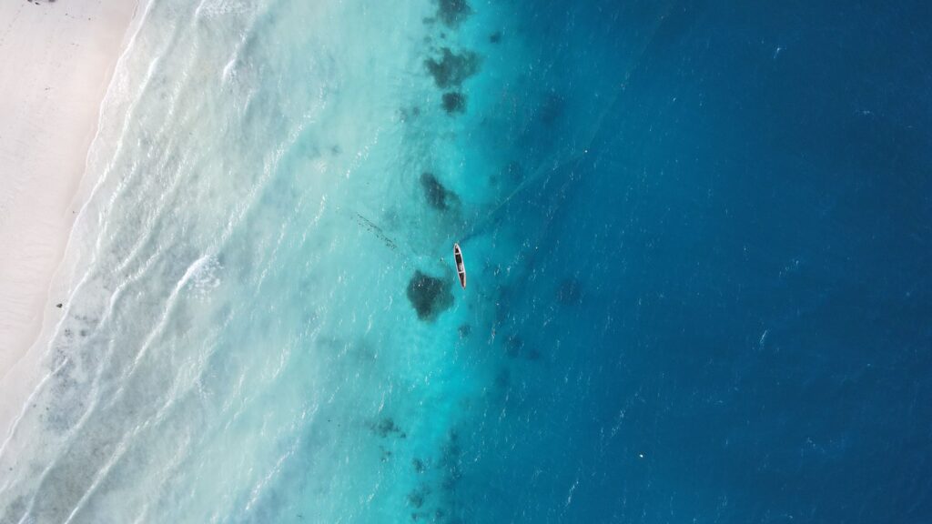 Aerial view of a boat on turquoise waters off Zanzibar, Tanzania