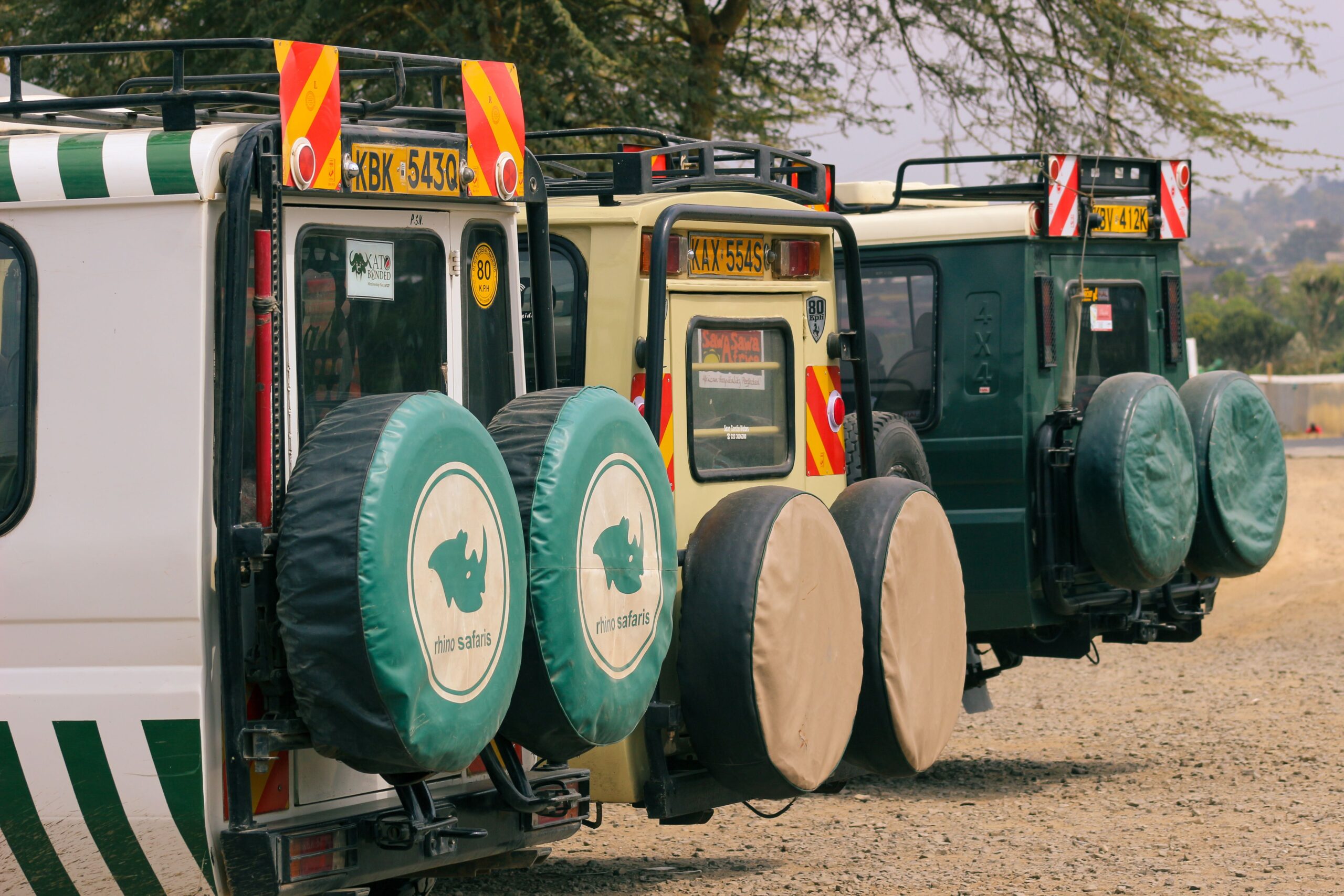 Kenya Safari 4x4 Hire 3 Parked Kenya safari 4x4 vehicles with no passengers visible