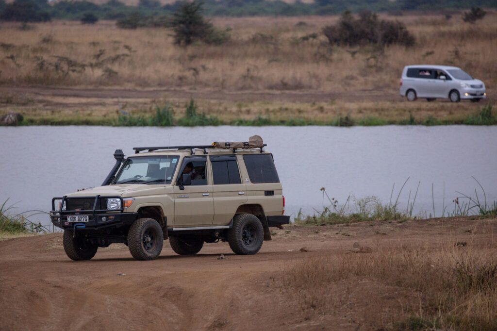 Tanzania Self-Drive 4x4 Hire 1 Empty safari 4x4 parked beside a lakeside African savanna for Tanzania self-drive hire