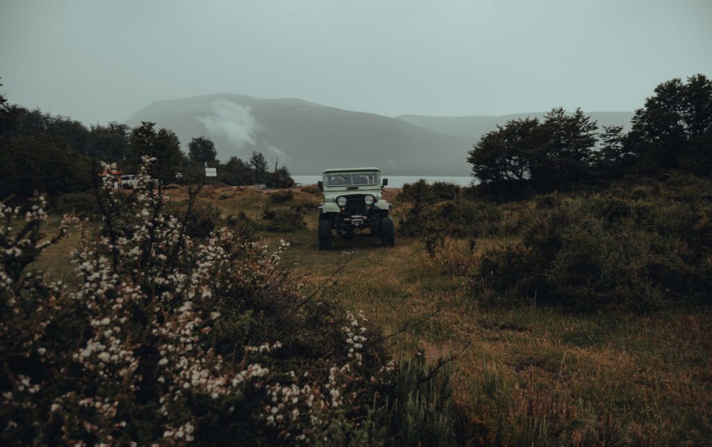 Empty 4x4 parked off-road in misty green landscape for Uganda self-drive