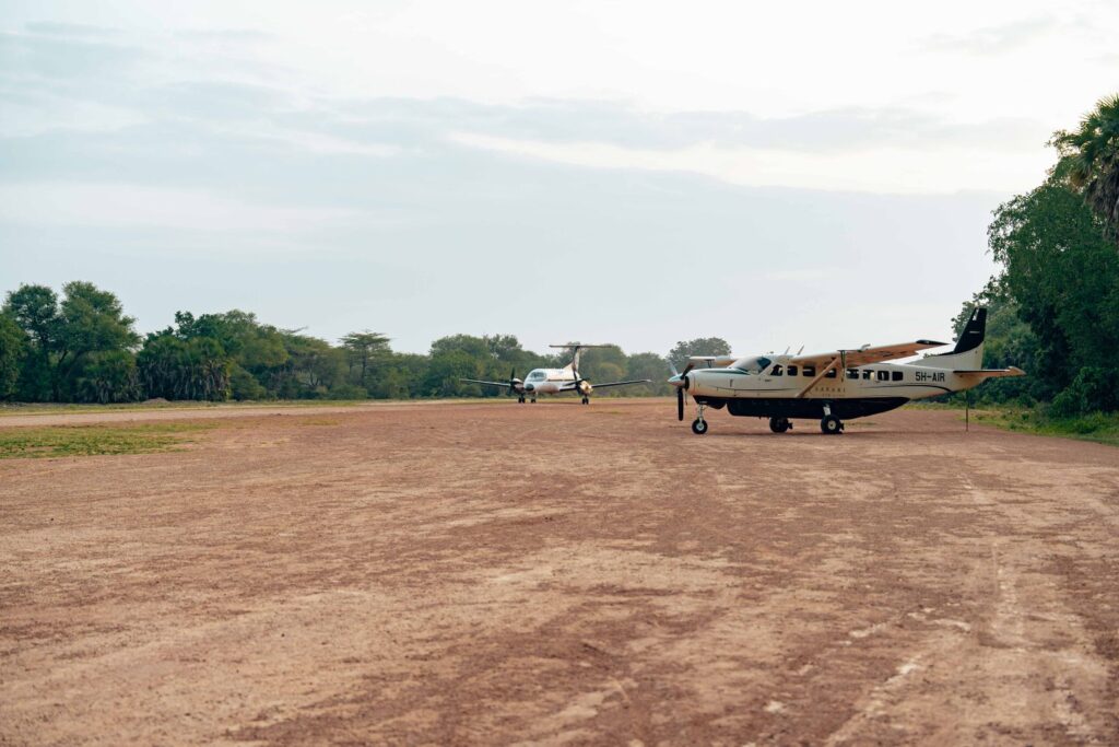 JKIA vs Wilson Airport for a Masai Mara Safari Week (2026) 2 Light aircraft parked on a safari bush airstrip used for Masai Mara flights