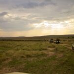 4x4 safari vehicles on the Kenyan savanna at sunset